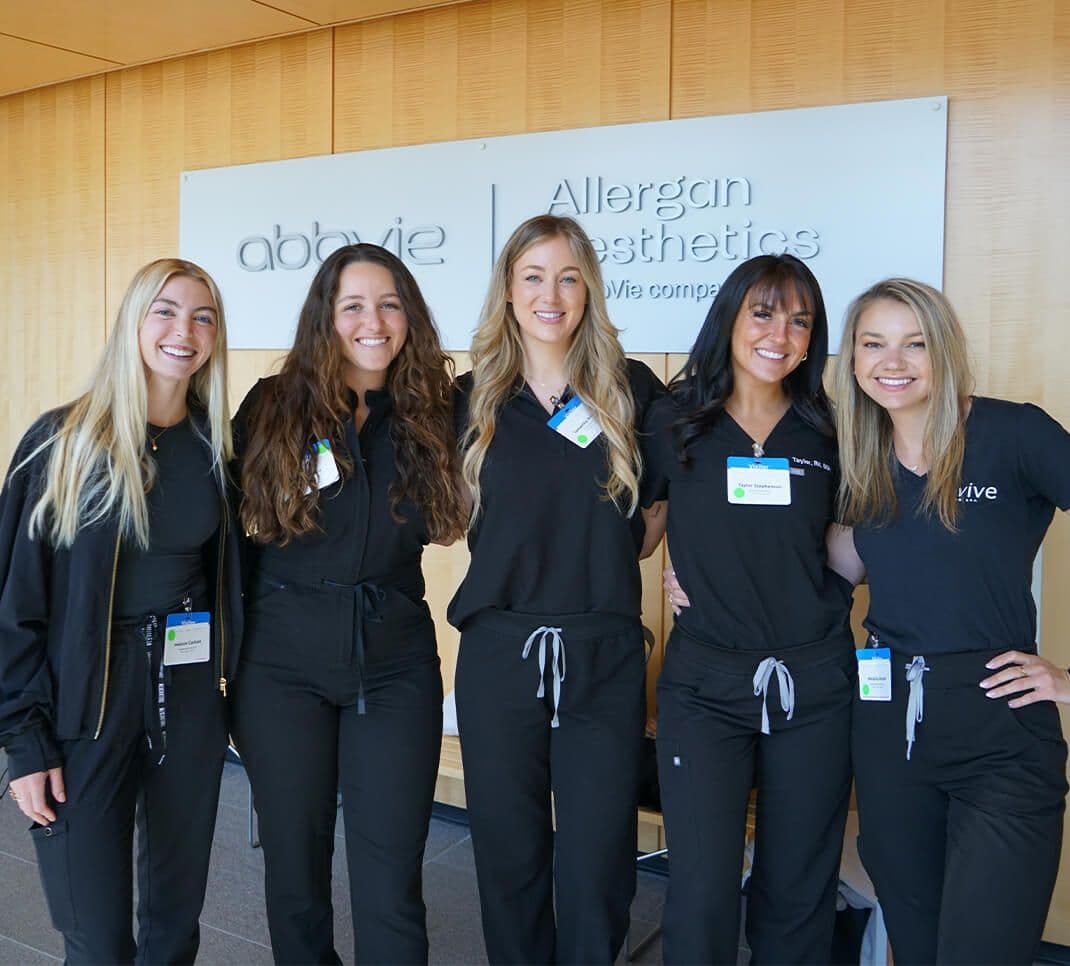 Five women standing and smiling