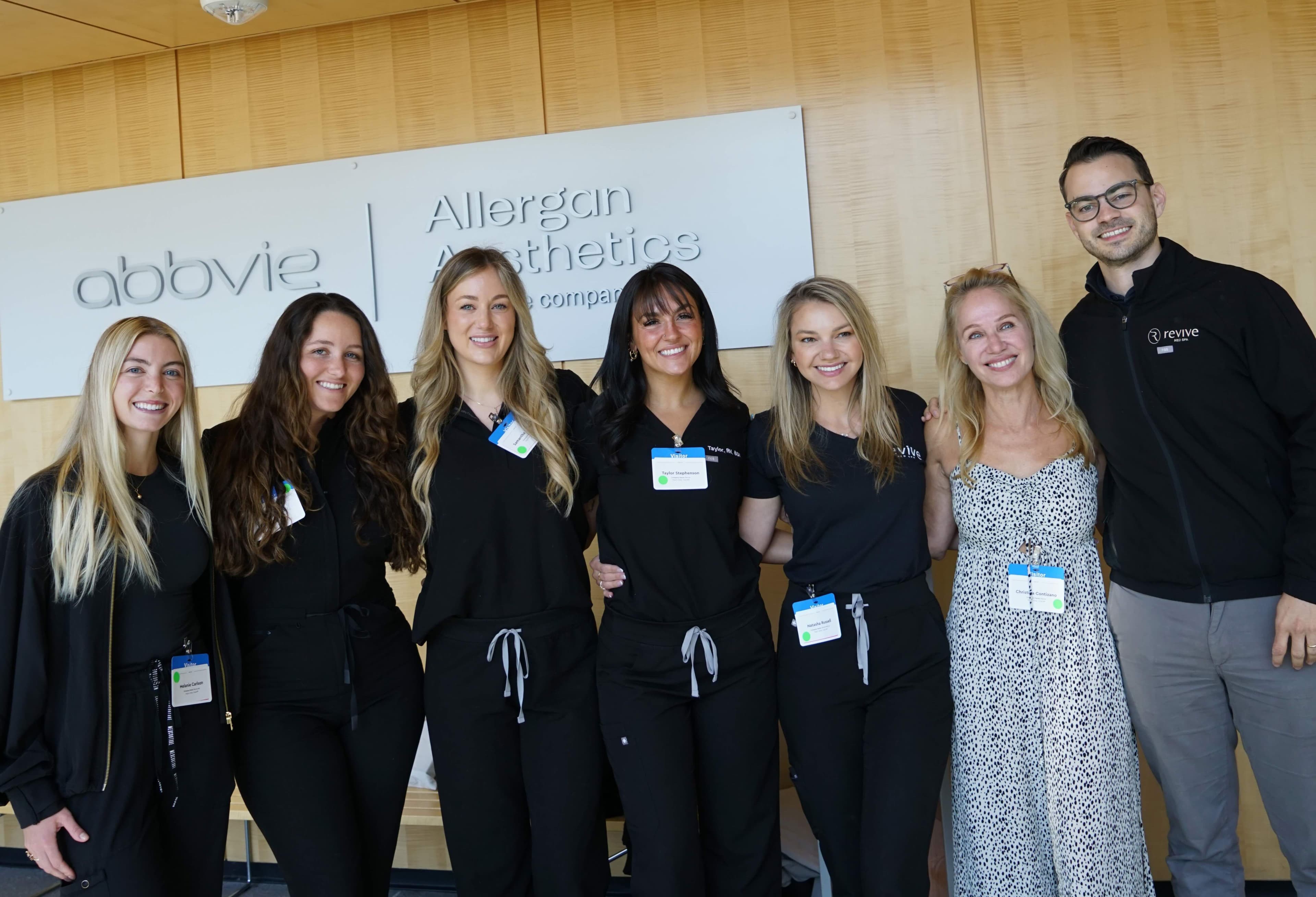 Revive Med Spa providers in black scrubs standing smiling at camera