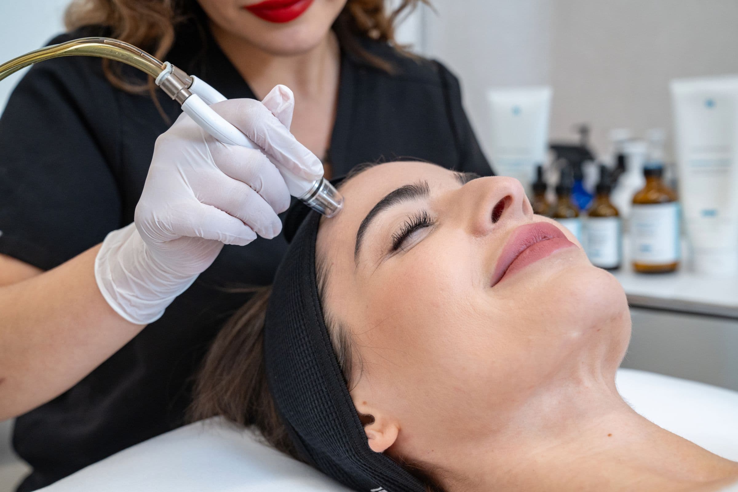 Woman receiving DiamondGlow facial treatment