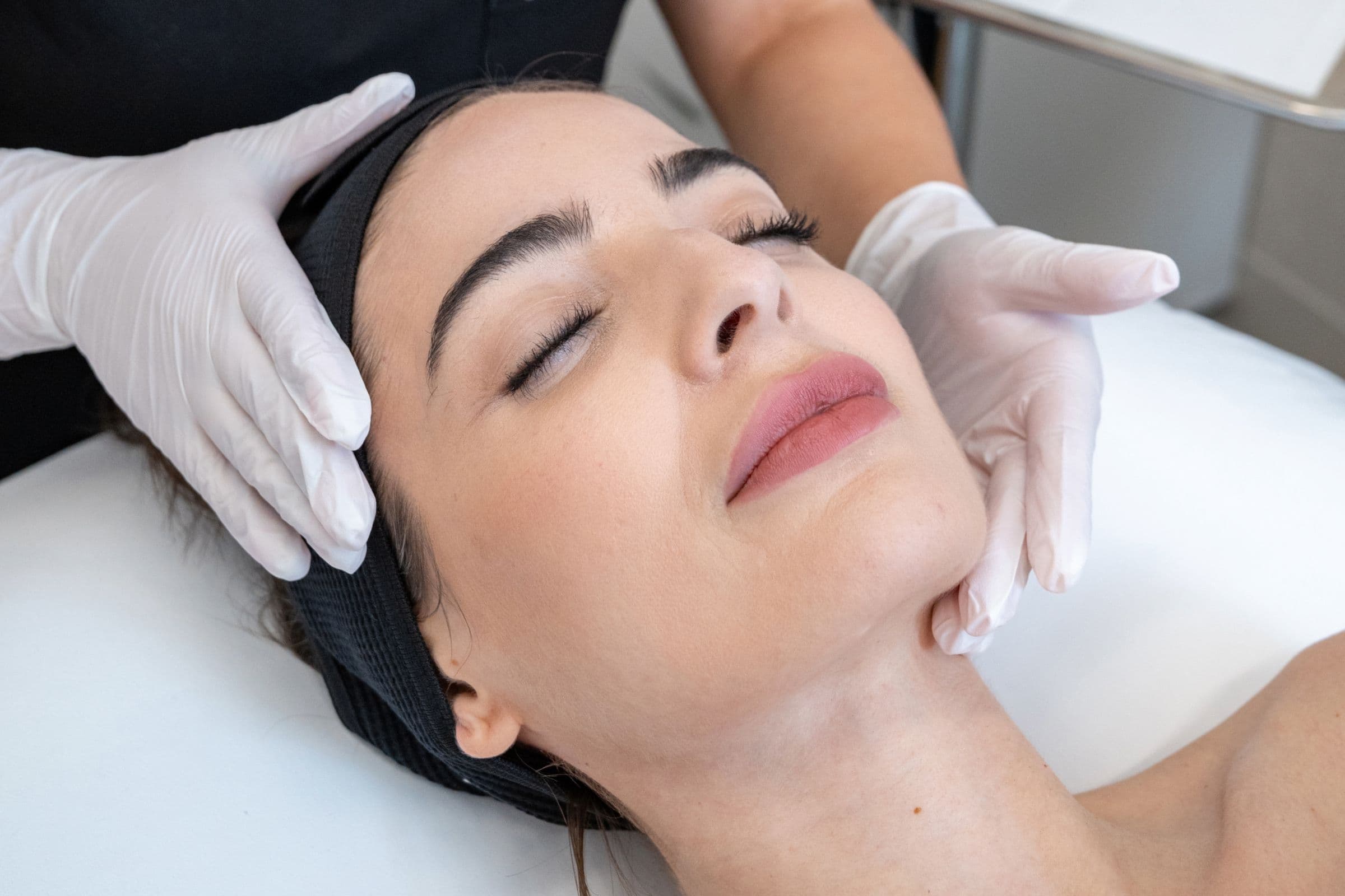 Woman receiving facial treatment